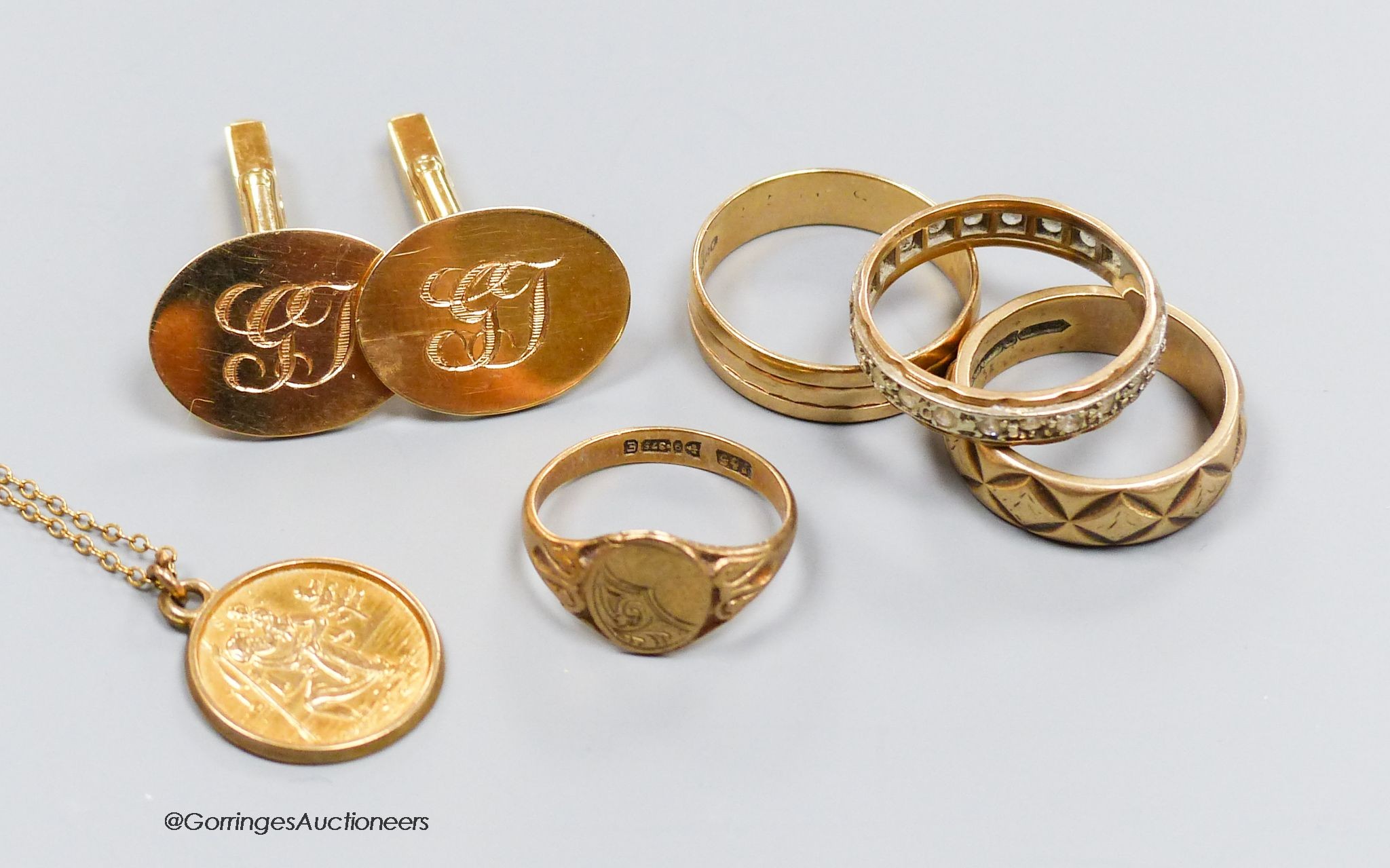 A pair of 9ct gold oval cufflinks with engraved initials, three various 9ct gold rings including paste set and a 9ct gold St Christopher pendant on gilt chain, gross 22.6g. total approx 20g